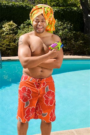 Man wearing towel turban by pool Stock Photo - Premium Royalty-Free, Code: 673-02141570