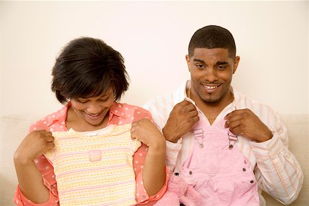 simsearch:673-02143115,k - Couple holding baby clothes against themselves Stock Photo - Premium Royalty-Free, Code: 673-02141690