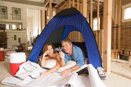 roughing it - Couple camping in their unfinished living room Stock Photo - Premium Royalty-Free, Code: 673-02141754