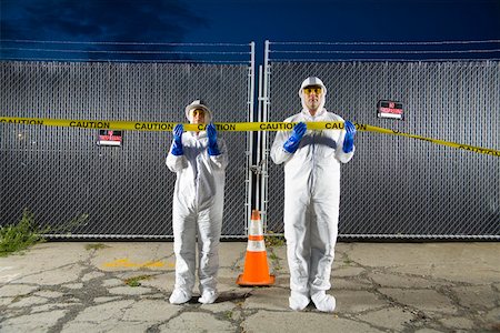 People in biohazard suits standing behind caution tape Stock Photo - Premium Royalty-Free, Code: 673-02141809