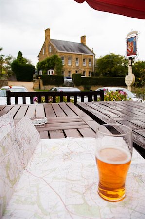 pub exterior - Pint of beer and map on outdoor pub table, Cotswolds, United Kingdom Stock Photo - Premium Royalty-Free, Code: 673-02141850