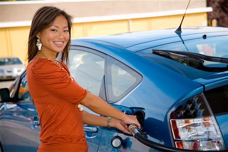 filling station - Portrait of woman pumping gas Stock Photo - Premium Royalty-Free, Code: 673-02142104