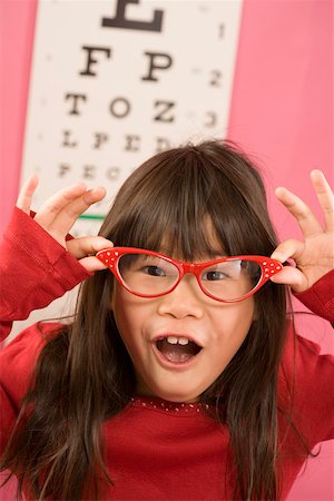 retro funny fashion pictures - Girl wearing eyeglasses in front of eye chart Stock Photo - Premium Royalty-Free, Code: 673-02142113