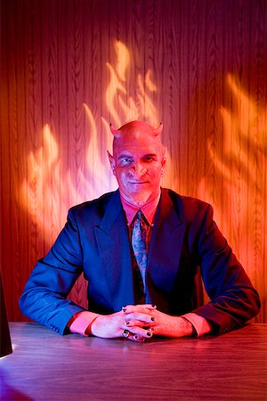 simsearch:673-02142270,k - Businessman dressed as devil at desk Stock Photo - Premium Royalty-Free, Code: 673-02142165