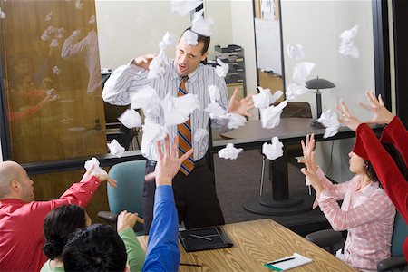 Businesspeople throwing paper at meeting Stock Photo - Premium Royalty-Free, Code: 673-02142279