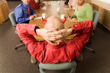 Businessman with devil horns at meeting Stock Photo - Premium Royalty-Free, Code: 673-02142270