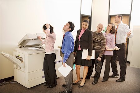 Businesspeople on line to use photocopy machine Stock Photo - Premium Royalty-Free, Code: 673-02142288