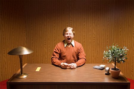 funny sales man pic - Businessman yawning at desk Stock Photo - Premium Royalty-Free, Code: 673-02142318