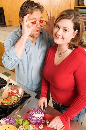 simsearch:673-02142407,k - Couple playing with food while cooking Stock Photo - Premium Royalty-Free, Code: 673-02142390