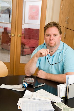 picture of fat man with money - Man paying bills Stock Photo - Premium Royalty-Free, Code: 673-02142416