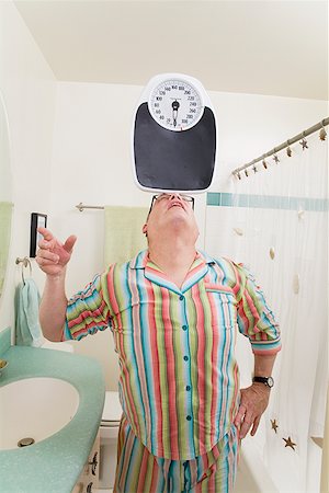 Man balancing a scale on his nose Stock Photo - Premium Royalty-Free, Code: 673-02142450