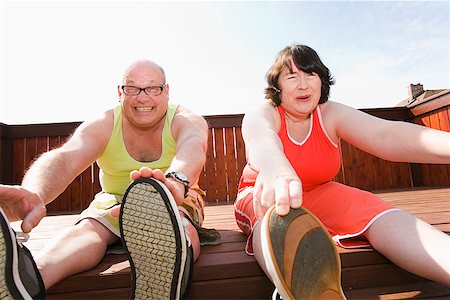 fat matures 40 year old man - Couple stretching on patio Stock Photo - Premium Royalty-Free, Code: 673-02142462