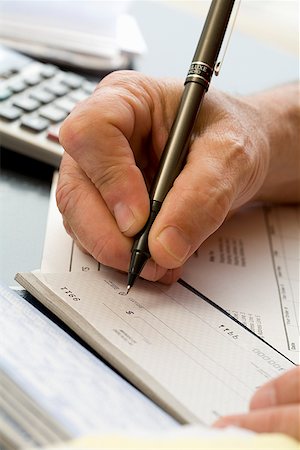 person writing in check book - Man writing a check Stock Photo - Premium Royalty-Free, Code: 673-02142508