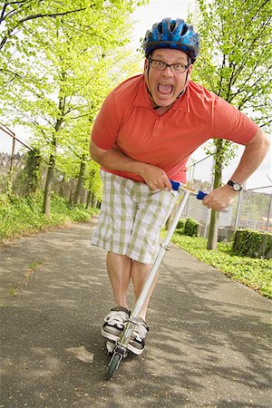 fat matures 40 year old man - Man riding a scooter Stock Photo - Premium Royalty-Free, Code: 673-02142526