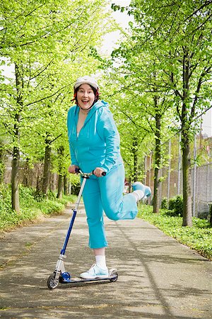 senior woman overweight - Woman riding a scooter Stock Photo - Premium Royalty-Free, Code: 673-02142544
