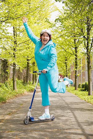 seniors fat - Woman riding a scooter Stock Photo - Premium Royalty-Free, Code: 673-02142545