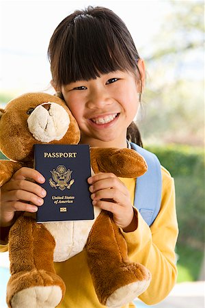 Young girl holding teddy bear and passport Stock Photo - Premium Royalty-Free, Code: 673-02142790