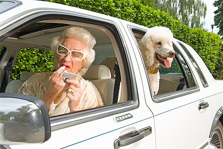 fashion woman dog - Senior woman applying lipstick in car Stock Photo - Premium Royalty-Free, Code: 673-02142801