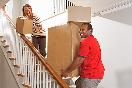 African couple carrying moving boxes Foto de stock - Sin royalties Premium, Código: 673-02142831