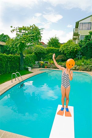 swimming pool housing - Girl with balloon in front of face over swimming pool Stock Photo - Premium Royalty-Free, Code: 673-02142845