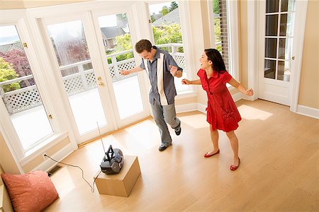 simsearch:673-02143029,k - Hispanic couple dancing in new house Stock Photo - Premium Royalty-Free, Code: 673-02143017