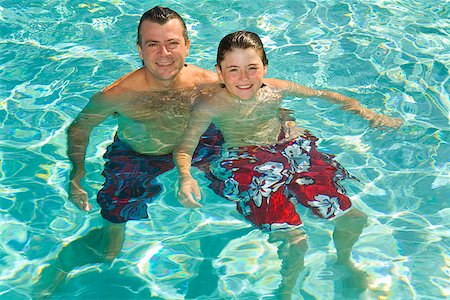 father and son swimming - Father and son in swimming pool Stock Photo - Premium Royalty-Free, Code: 673-02143077