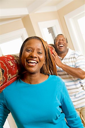 African couple carrying rug Stock Photo - Premium Royalty-Free, Code: 673-02143144
