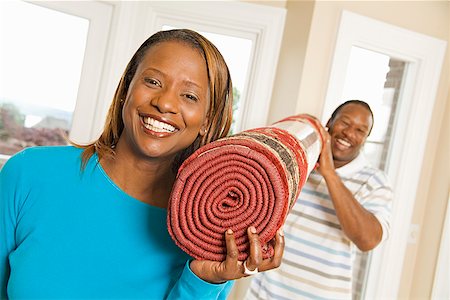 African couple carrying rug Stock Photo - Premium Royalty-Free, Code: 673-02143147