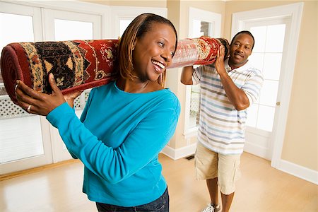 African couple carrying rug Stock Photo - Premium Royalty-Free, Code: 673-02143142