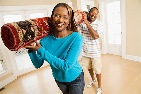satisfied african american man - African couple carrying rug Stock Photo - Premium Royalty-Free, Code: 673-02143143