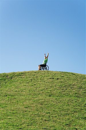 single man in arm of nature - Person in wheelchair on top of hill Stock Photo - Premium Royalty-Free, Code: 673-02143275