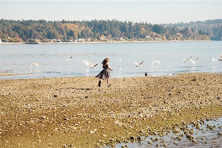 pursue - Girl running on beach in party dress Stock Photo - Premium Royalty-Free, Code: 673-02143297