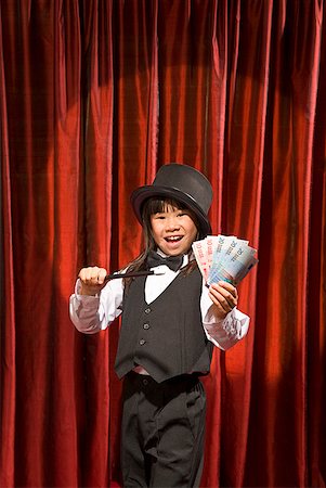 financial highlights - Asian girl performing magic trick on stage Stock Photo - Premium Royalty-Free, Code: 673-02143351