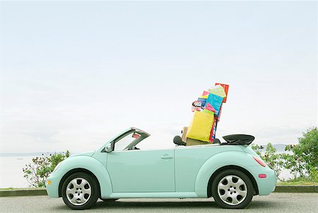 shopping humour - Convertible car with shopping bags in backseat Stock Photo - Premium Royalty-Free, Code: 673-02143384