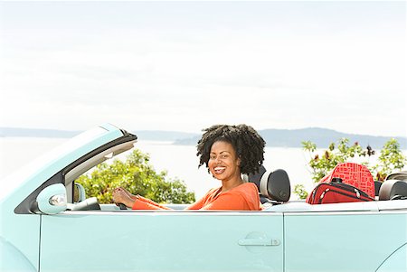 African woman driving convertible car Stock Photo - Premium Royalty-Free, Code: 673-02143404