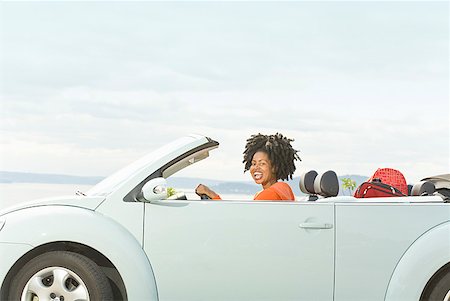 sky sea and car - African woman driving convertible car Stock Photo - Premium Royalty-Free, Code: 673-02143407