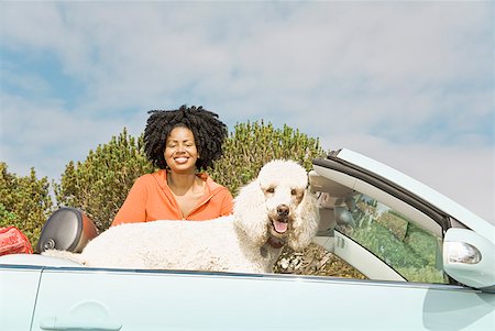 dog road trip - African woman and dog in convertible car Stock Photo - Premium Royalty-Free, Code: 673-02143426