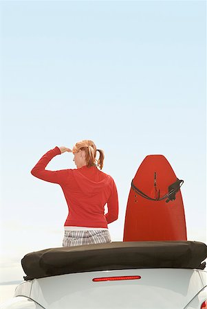 Woman and surfboard in convertible car Stock Photo - Premium Royalty-Free, Code: 673-02143435