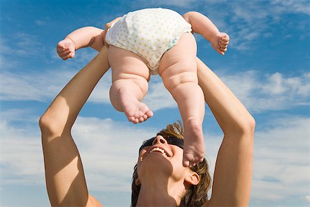 Mother holding baby up in air Stock Photo - Premium Royalty-Free, Code: 673-02143624