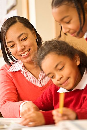 simsearch:673-02143687,k - African female teacher helping student Stock Photo - Premium Royalty-Free, Code: 673-02143654