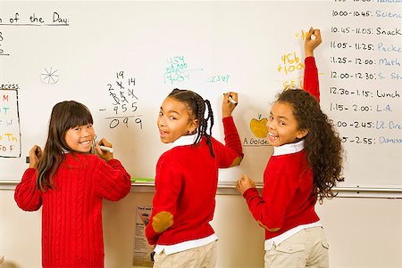 student enjoying in math class - Multi-ethnic girls writing on whiteboard Stock Photo - Premium Royalty-Free, Code: 673-02143659