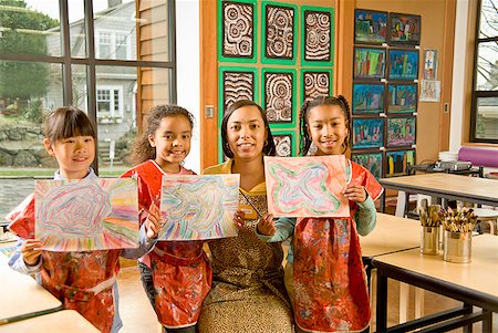 African art teacher and students holding paintings Stock Photo - Premium Royalty-Free, Code: 673-02143671