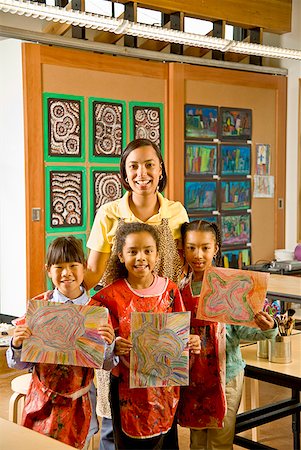 African art teacher and students holding paintings Stock Photo - Premium Royalty-Free, Code: 673-02143672