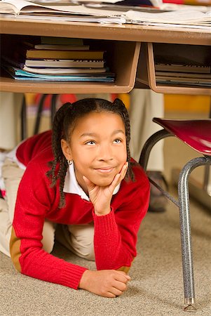 school for bad kids - African girl sitting under school desk Stock Photo - Premium Royalty-Free, Code: 673-02143684