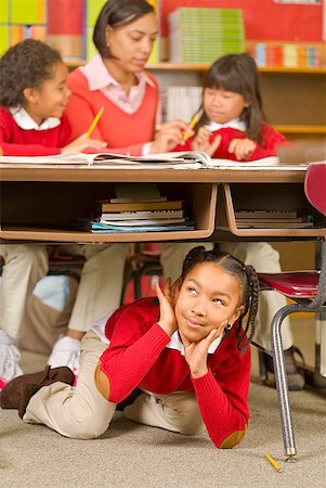 simsearch:673-02143704,k - African girl sitting under school desk Foto de stock - Royalty Free Premium, Número: 673-02143687