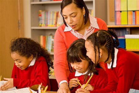 simsearch:673-02143362,k - African female teacher helping students Stock Photo - Premium Royalty-Free, Code: 673-02143688
