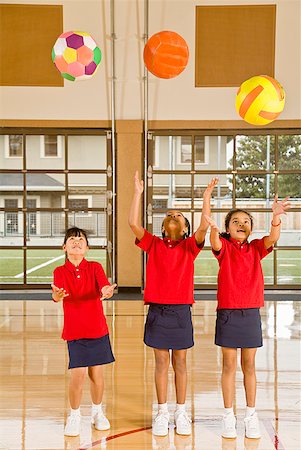 student jumping to school - Multi-ethnic girls throwing sports balls Foto de stock - Sin royalties Premium, Código: 673-02143720