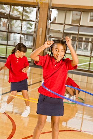 school and uniform and african - Multi-ethnic girls playing with hula hoops Stock Photo - Premium Royalty-Free, Code: 673-02143723