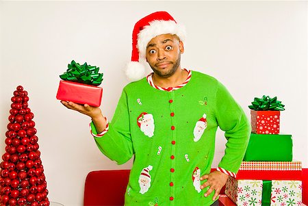 African man holding Christmas gift Stock Photo - Premium Royalty-Free, Code: 673-02143815