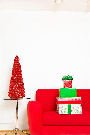 drawing room without people - Stack of Christmas gifts on sofa Stock Photo - Premium Royalty-Free, Code: 673-02143840